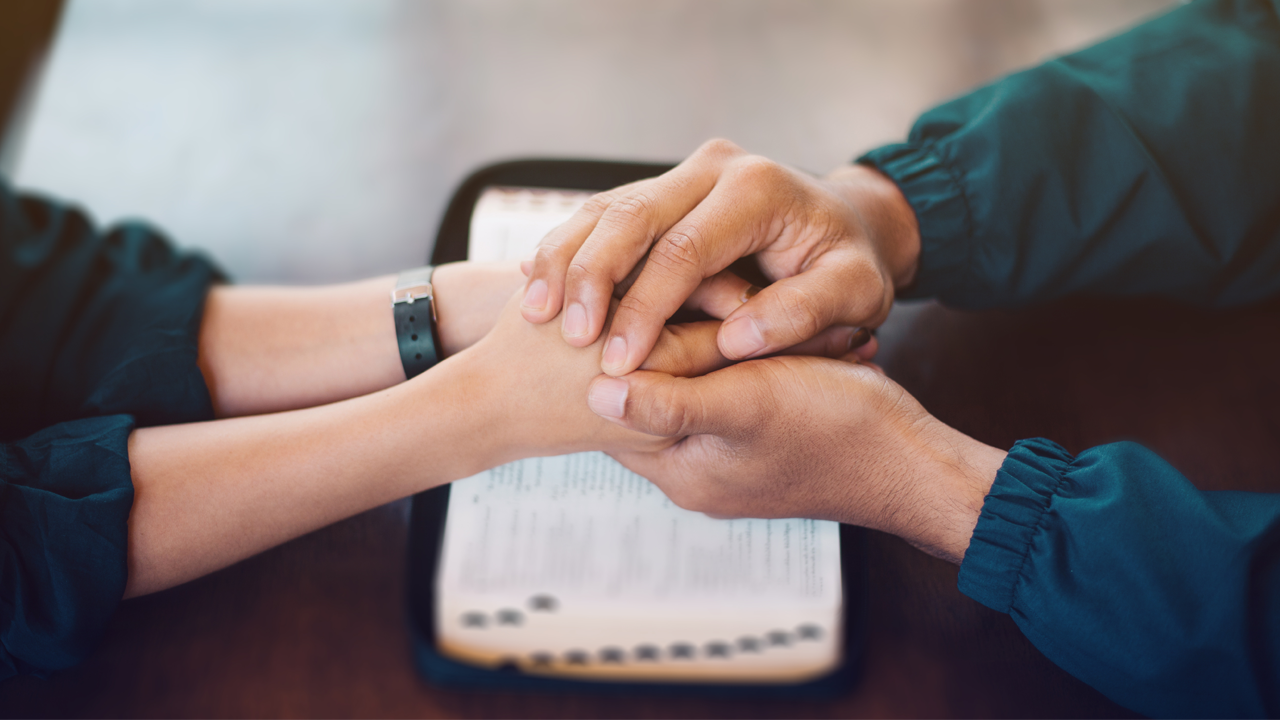 Two people's hands in prayer during a session at the Prayer house ministry in Harrisburg PA.