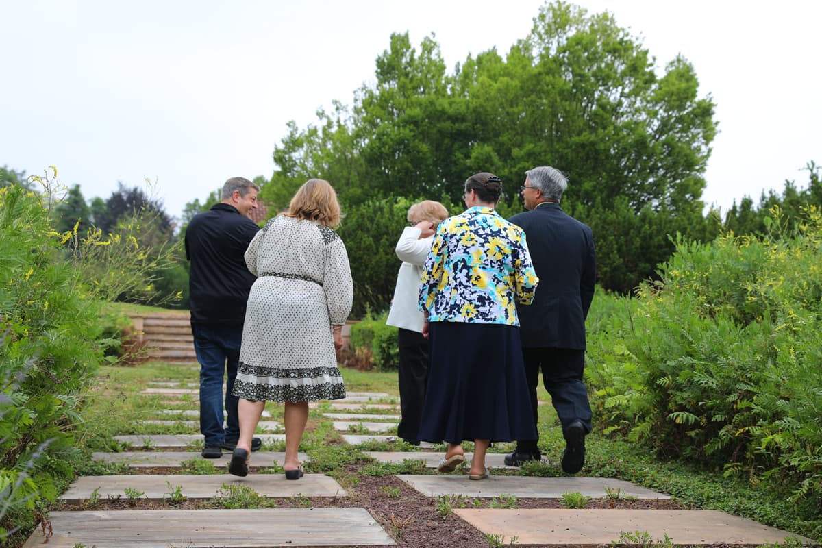 Donors walking through the Agape Gardens at Servant's Oasis.